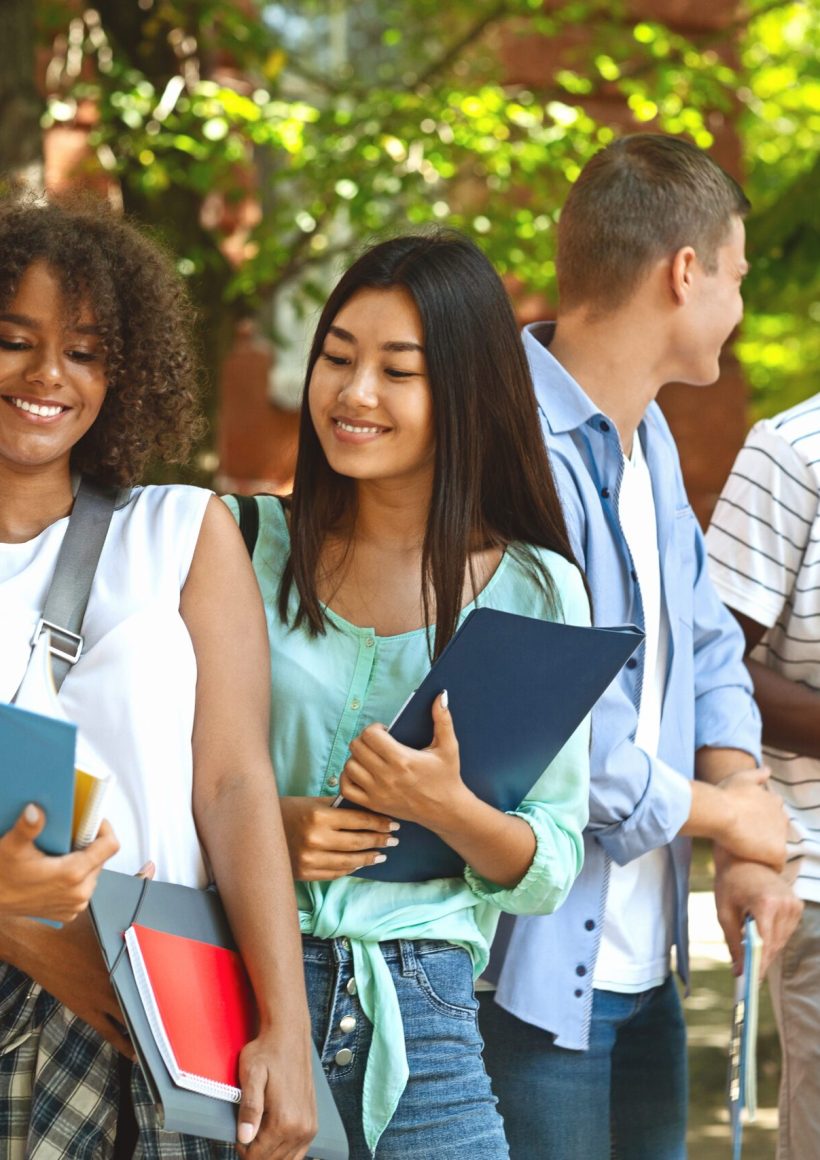 group,of,international,students,resting,in,campus,outdoors,during,break